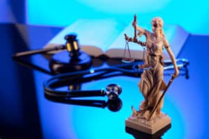 Medical,Law,Concept.,Judges,Gavel,,Stethoscope,,Blue,Light.