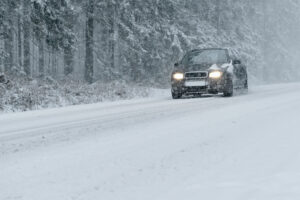 Car driving on snowy winter road