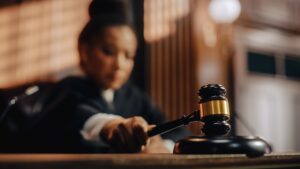 Judge striking gavel in courtroom before personal injury trial