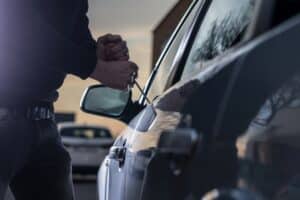 Person breaking into someone's car