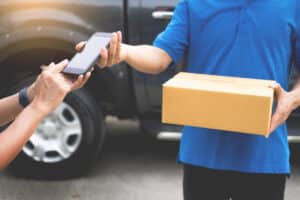 Delivery man waiting for customer to sign for package